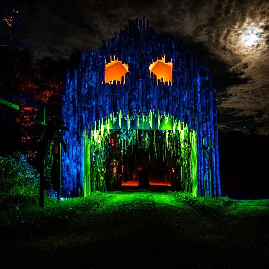 A light up neon spooky tree with scary face